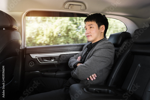 business man sitting at the back seat of car © geargodz