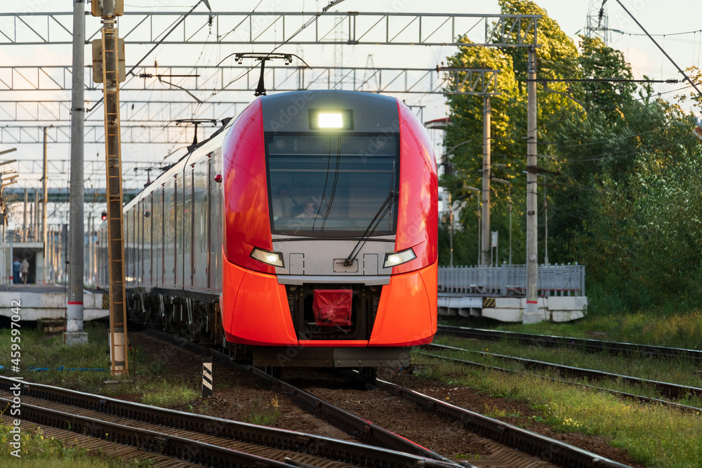Front view of modern russian intercity high speed train on railway platform. Industrial landscape with passenger train on railroad in Europe. Commercial suburban transportation concept
