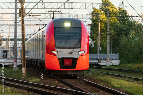 Front view of modern russian intercity high speed train on railway platform. Industrial landscape with passenger train on railroad in Europe. Commercial suburban transportation concept