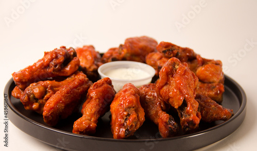 Hot and spicy buffalo chicken wings close up on a white background
