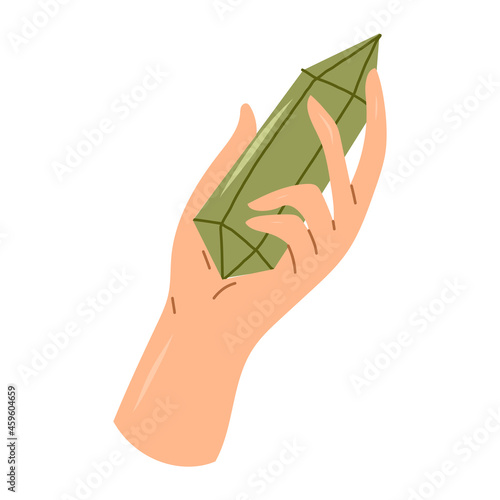 Hand holding green stone cryslal quartz. Esoteric and mystical design element.