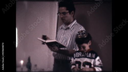 Sabbath Blessing 1975 - A boy helps his father with the Sabbath blessing. photo