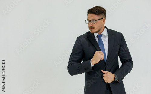 Isolated portrait studio shot of Caucasian masculine handsome smart confident professional successful businessman in formal black suit optical eyeglasses standing look at camera on white background