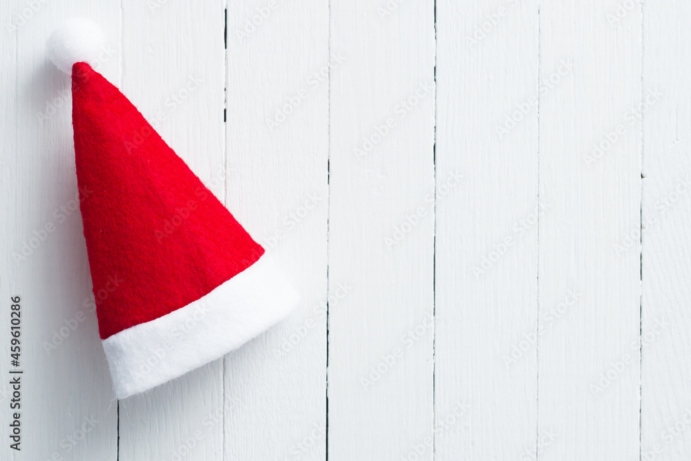 red Santa Claus hat on white wooden table background red Santa Claus hat on white wooden table background