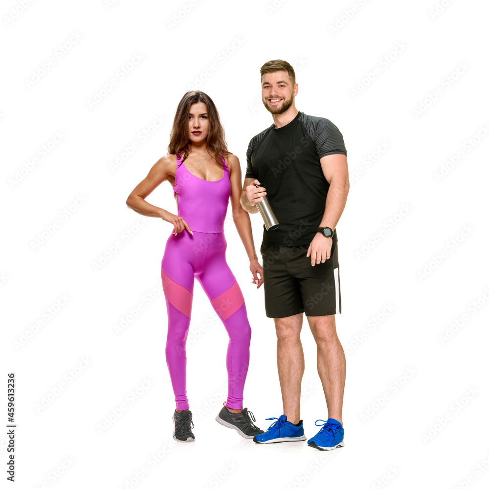 Fototapeta premium Full portrait of healthy athletic man and woman posing together, healthy lifestyle, the need for physical activity in the modern world