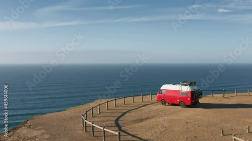 Cordoama Viewpoint. Sagres. Portugal. Scenic views over pristine beach, where green peaks reach the sea. Drone footage of cinematic van on a viewpoint on the edge of a cliff. High quality 4k footage photo
