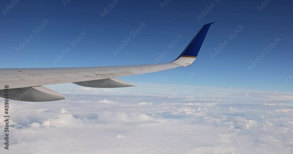 Wing of an airplane flying above the clouds of aircraft Wing of an airplane flying above the clouds of aircraft