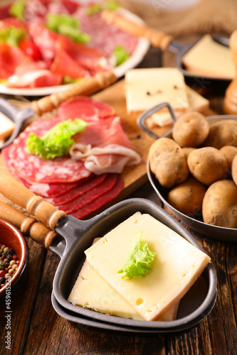 raclette cheese with potato and meats