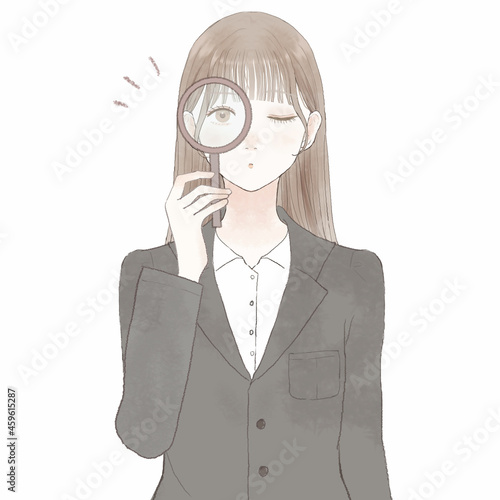 ルーペを使ってチェックしているスーツを着た女性