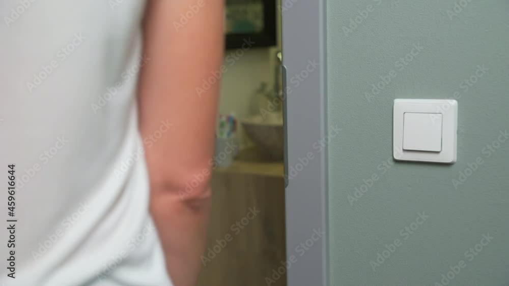 Woman open white door with a handle and entrance in the room.Element of interior Woman open white door with a handle and entrance in the room.Element of interior