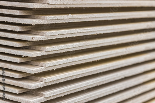 A stack of drywall in close-up. The texture of drywall sheets.