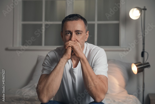 Depressed mature man in bed...