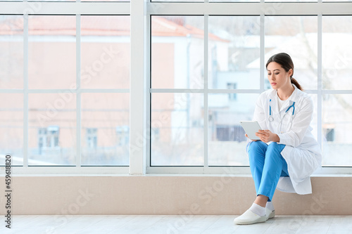 Female Asian doctor with ta...