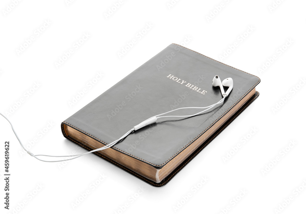 Holy Bible and earphones on white background Holy Bible and earphones on white background