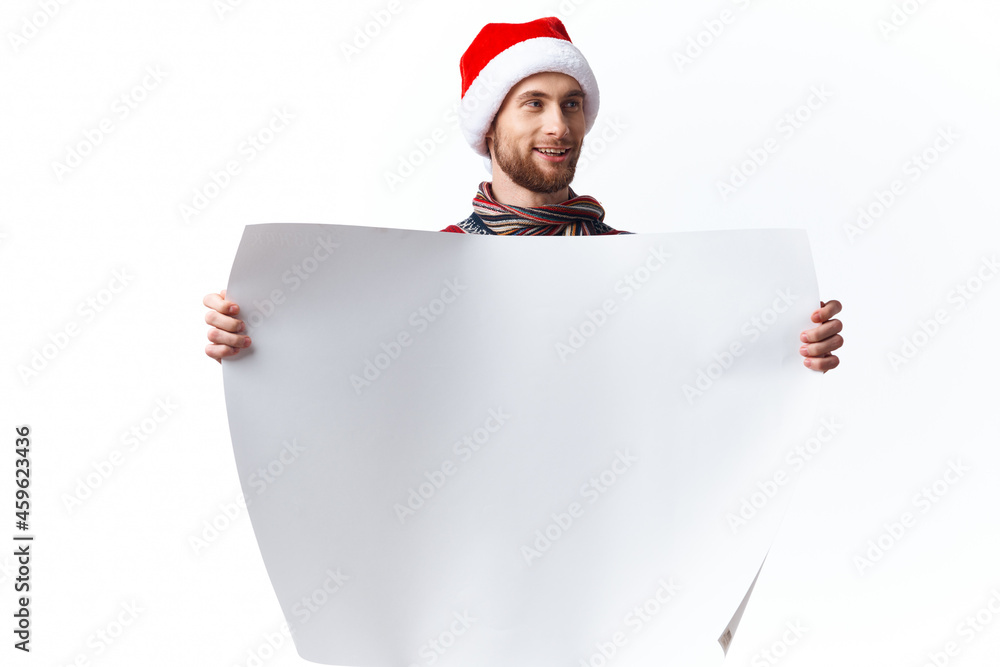 handsome man in a christmas hat with white mockup poster christmas copy-space studio handsome man in a christmas hat with white mockup poster christmas copy-space studio
