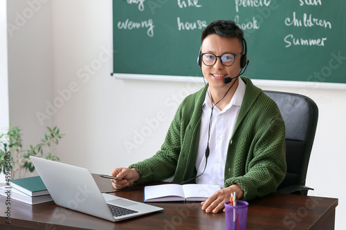 Asian teacher conducting En...