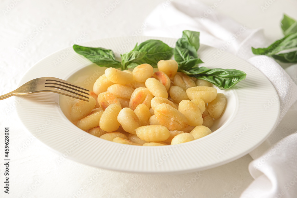 Plate with tasty gnocchi on light background Plate with tasty gnocchi on light background