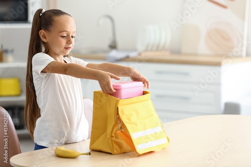 Cute little girl putting he...
