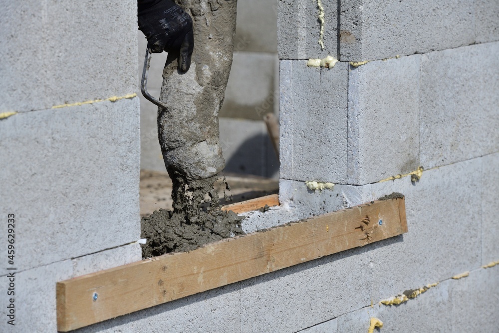 Concreting the walls using a pump machine during the construction of the house Concreting the walls using a pump machine during the construction of the house