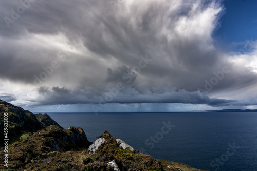 dark clouds with rain and thunderstorm over the atlantic ocean at the wild atlantic way in ireland