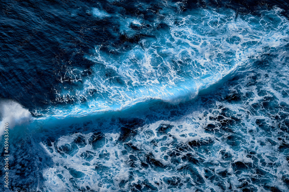 Aerial view to waves in ocean Splashing Waves. Blue clean wavy sea water.  Photos | Adobe Stock