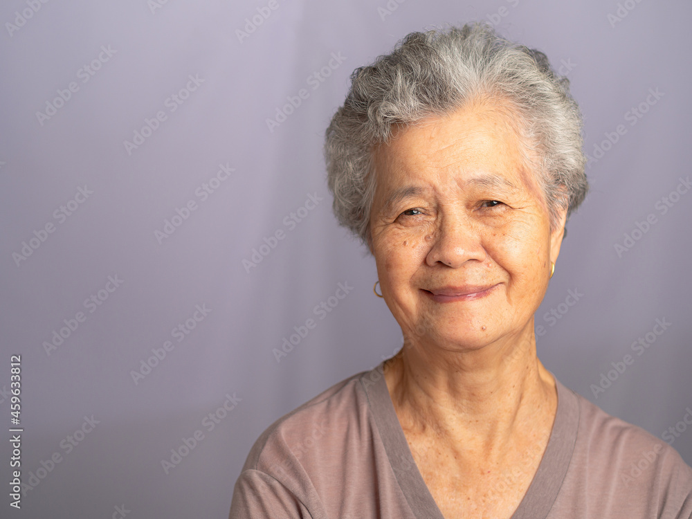 Premium AI Image  Elegant smiling elderly chic Asian woman with gray hair  and perfect skin on creamy beige backgroun