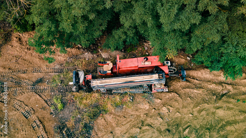 Horizontal directional drilling technology. Aerial view of Drilling machine work process. Trenchless laying of communications, pipes and water pipes photo