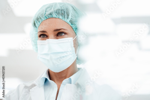 Female pharmacist wearing protective face mask at pharmacy during COVID-19 photo