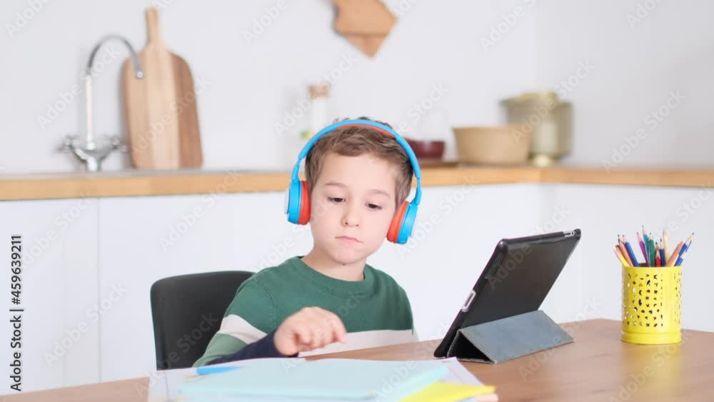 cute little boy watching cartoons on a tablet cute little boy watching cartoons on a tablet