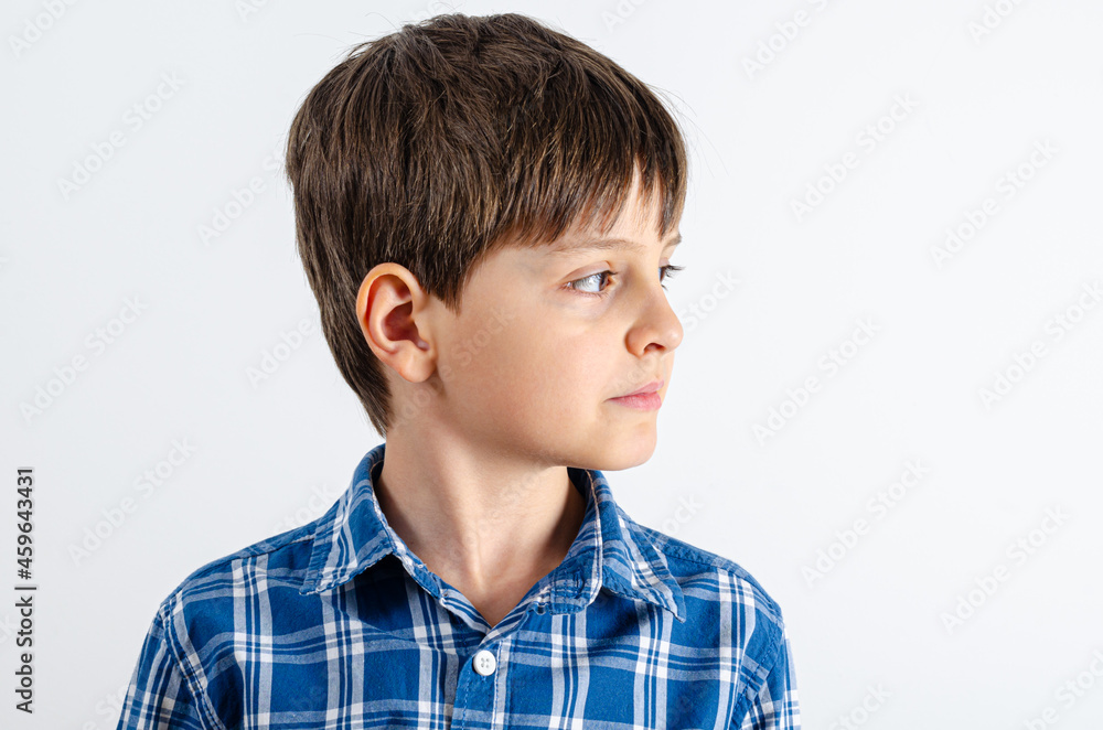 Kid in blue plaid shirt looking right side Kid in blue plaid shirt looking right side