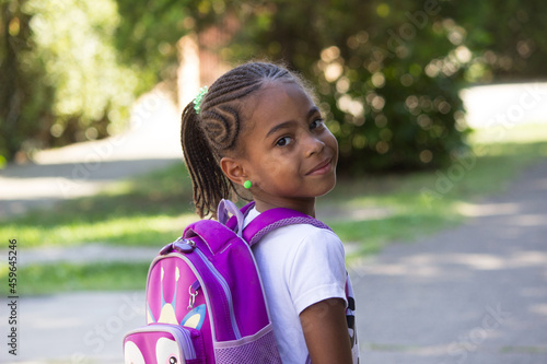 Happy little girl with backpack