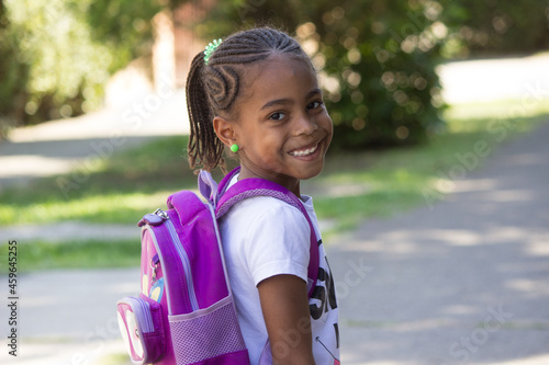 Happy little girl with backpack