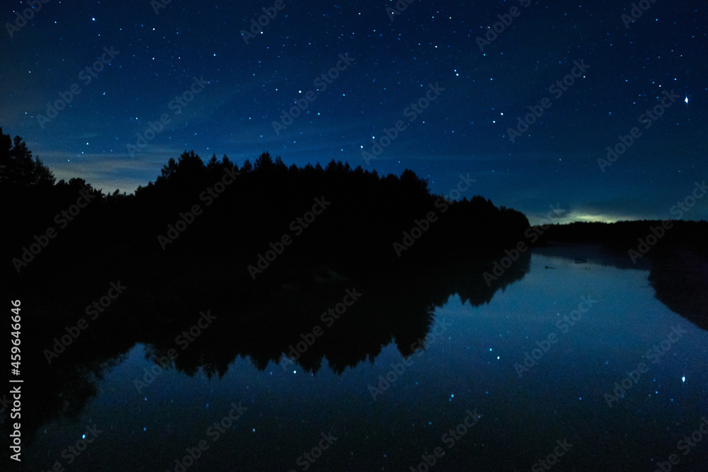 Fog on the river on a starry night in the forest. Dubna river, Moscow region, Russia.