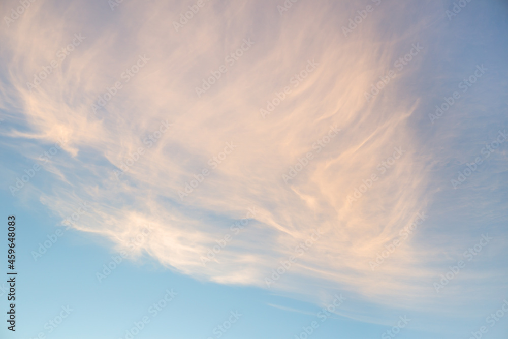 Obraz premium Clouds construction in sunset under blue sky.