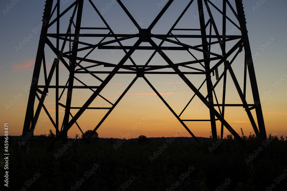 A power pole in the sunset. 
Silhouette.