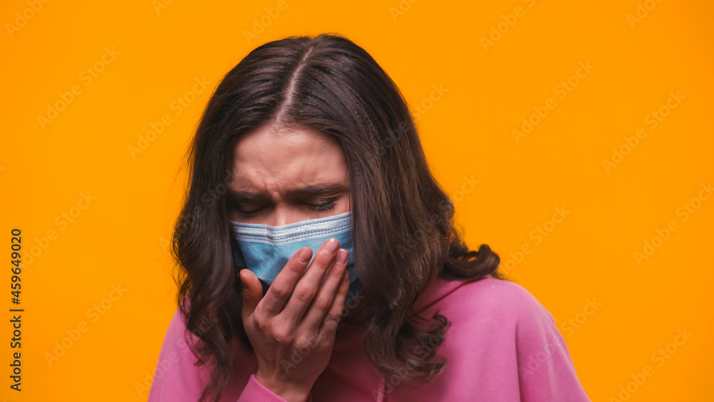 sick woman in medical mask coughing isolated on yellow sick woman in medical mask coughing isolated on yellow