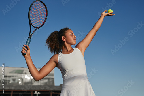 Confident black tennis player with racket and ball © kegfire