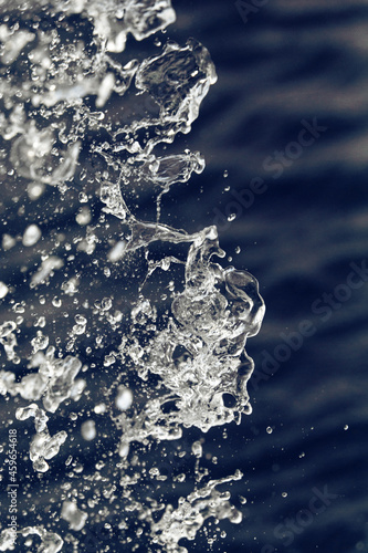 Water splashes on the left on a dark blue background