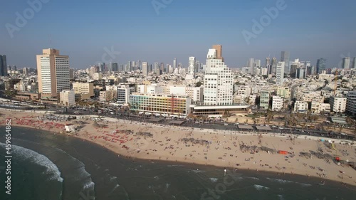 Aerial view overlooking beaches and the cityscape of Tel Aviv, in sunny Israel - pan, drone shot photo