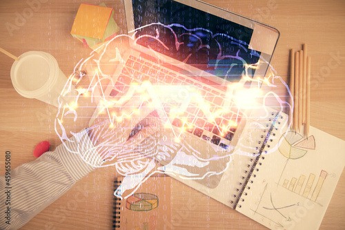 Double exposure of man's hands typing over computer keyboard and brain hologram drawing. Top view. Ai and data technology concept.