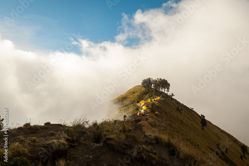 Line of colourful tents of top of the mountain. Trek to Mount Rinjani, Lombok, Indonesia