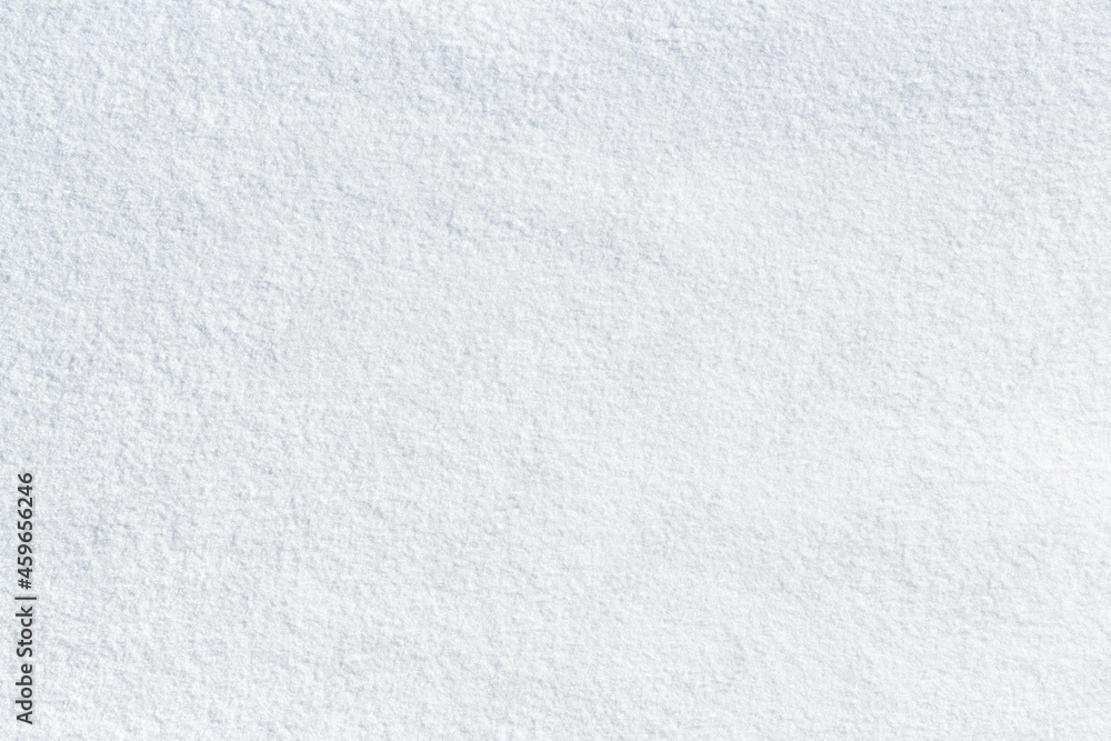 Naklejka premium Natural snow texture. Smooth surface of clean fresh snow. Snowy ground. Winter background with snow patterns. Perfect for Christmas and New Year design. Closeup top view.