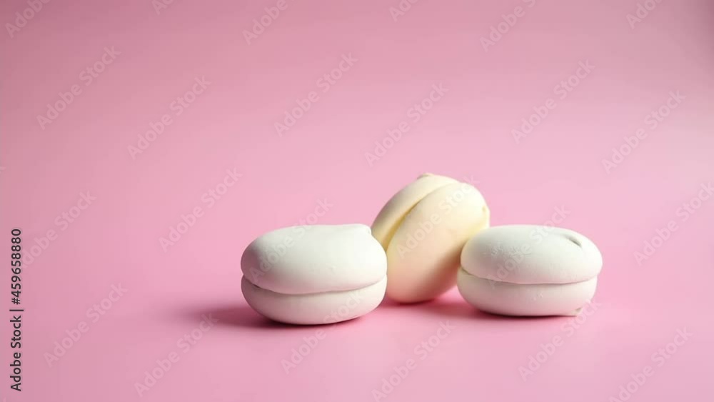 Video of marshmallow, soft confectionery, sweets on a pink background. Video of marshmallow, soft confectionery, sweets on a pink background.