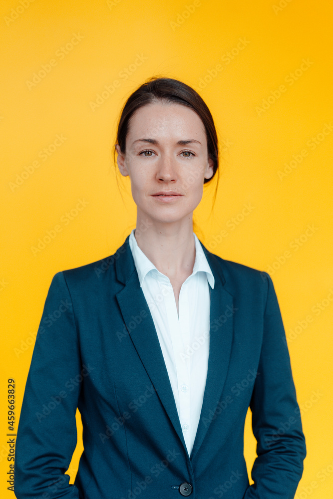 Businesswoman standing against yellow background Businesswoman standing against yellow background