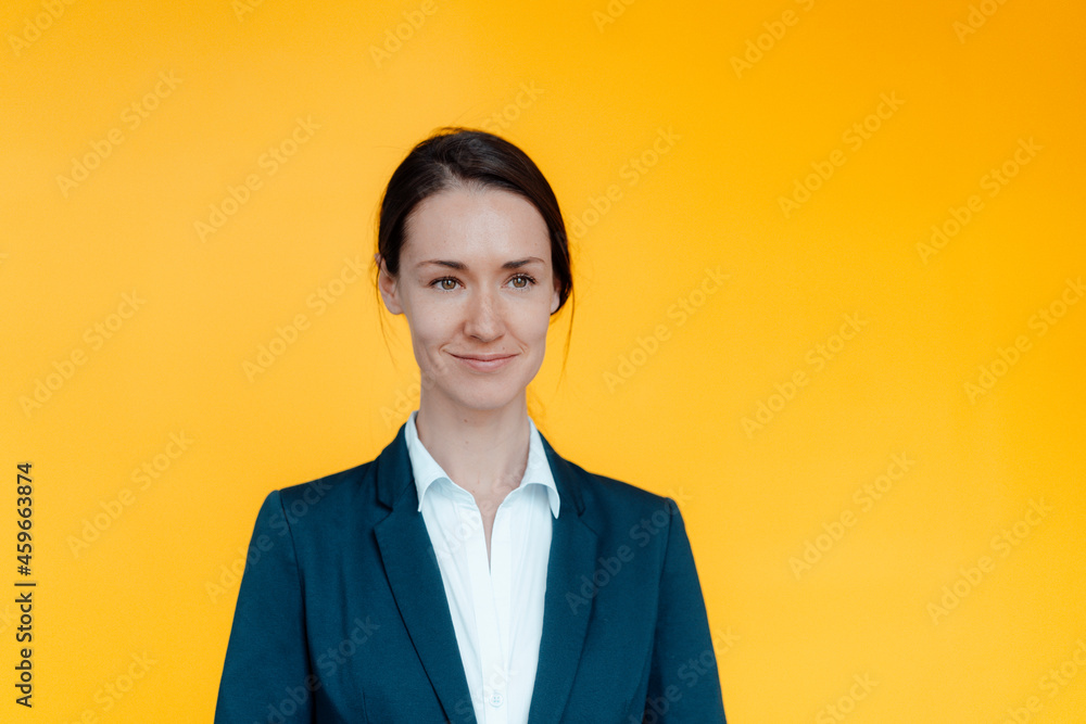 Smiling female business professional against yellow background Smiling female business professional against yellow background
