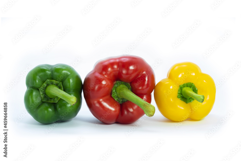 Three bell pepers is red, green and yellow on white background. Colorful vegetables. Three bell pepers is red, green and yellow on white background. Colorful vegetables.