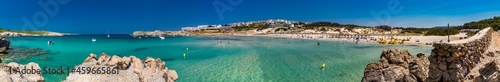 Spain, Balearic Islands, Menorca, Son Parc, Panorama of Platja Arenal den Castell bay in summer with town in background photo