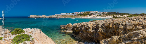 Spain, Balearic Islands, Menorca, Son Parc, Panorama of Platja Arenal den Castell bay in summer with town in background photo