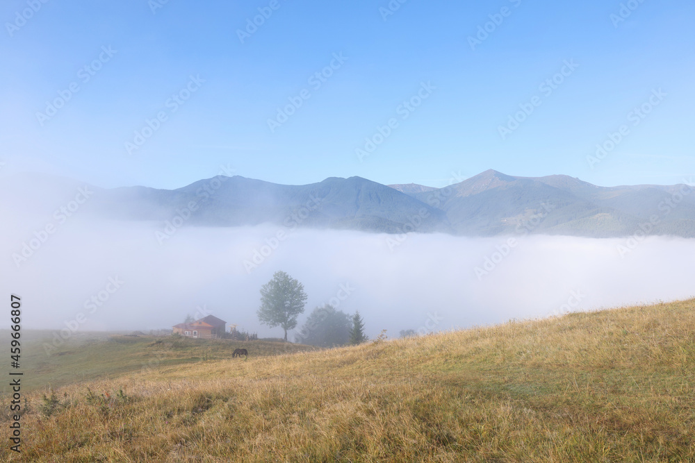 Beautiful view of landscape with foggy mountain hills