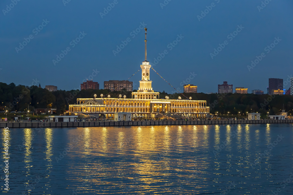 Brightly illuminated evening building of the Northern River Station. Built in 1937. Opened after reconstruction in 2020. Moscow, Russia